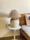 Caramel coloured terracotta lamp glowing in cozy living space