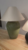 Close-up of handcrafted olive green lamp base with earthy tone