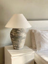 Matte textured lamp styled on wooden surface in living room

