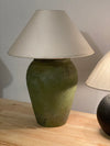 Side view of olive green lamp showing textured hand-finished body